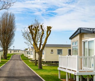 A row of caravans at our park in Essex, Mersea Island on a sunny, cloudy day.