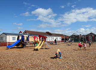 An image of the adventure playground at our stunning holiday park in North Wales, Golden Sands. There are children playing in the park on a summers day. image