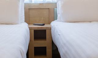 The twin bedroom at one of our bright and spacious indulgent static caravans. The perfect way to stay. image