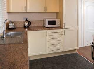 The interior of one of our Superior lodges. There's a spacious kitchen area with multiple appliances. image