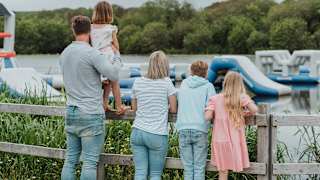 A young family looking over the watersports taking place on the lake at our stunning Retallack Resort & Spa.