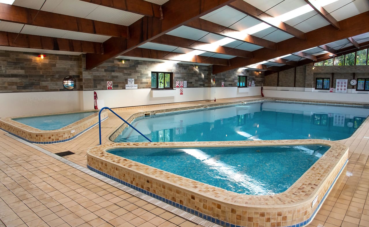 An image of a indoor swimming pool with clear blue water at one of our holiday parks. image
