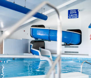 Indoor heated pool with flume