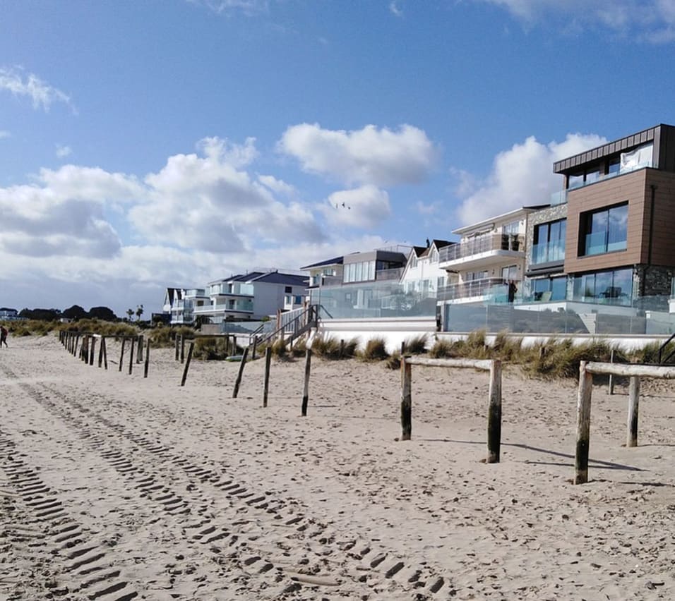 An image of Sandbanks Beach in Dorset. You can see the golden sand and houses overlooking the beach. image
