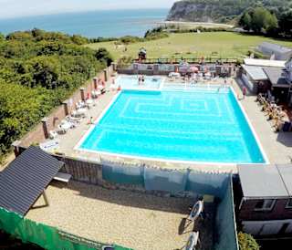A hot summer's day overlooking our outdoor pool at Whitecliff Bay. Come see for yourself when you visit the Isle of Wight on your next caravan holiday.