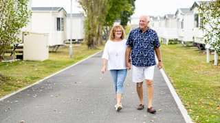A couple walking through one of our holiday parks.