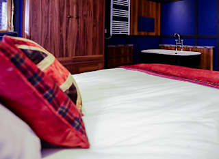 The master bedroom with bath tub at one of our exclusive accommodations, The Rockstar. Book your holiday now! image
