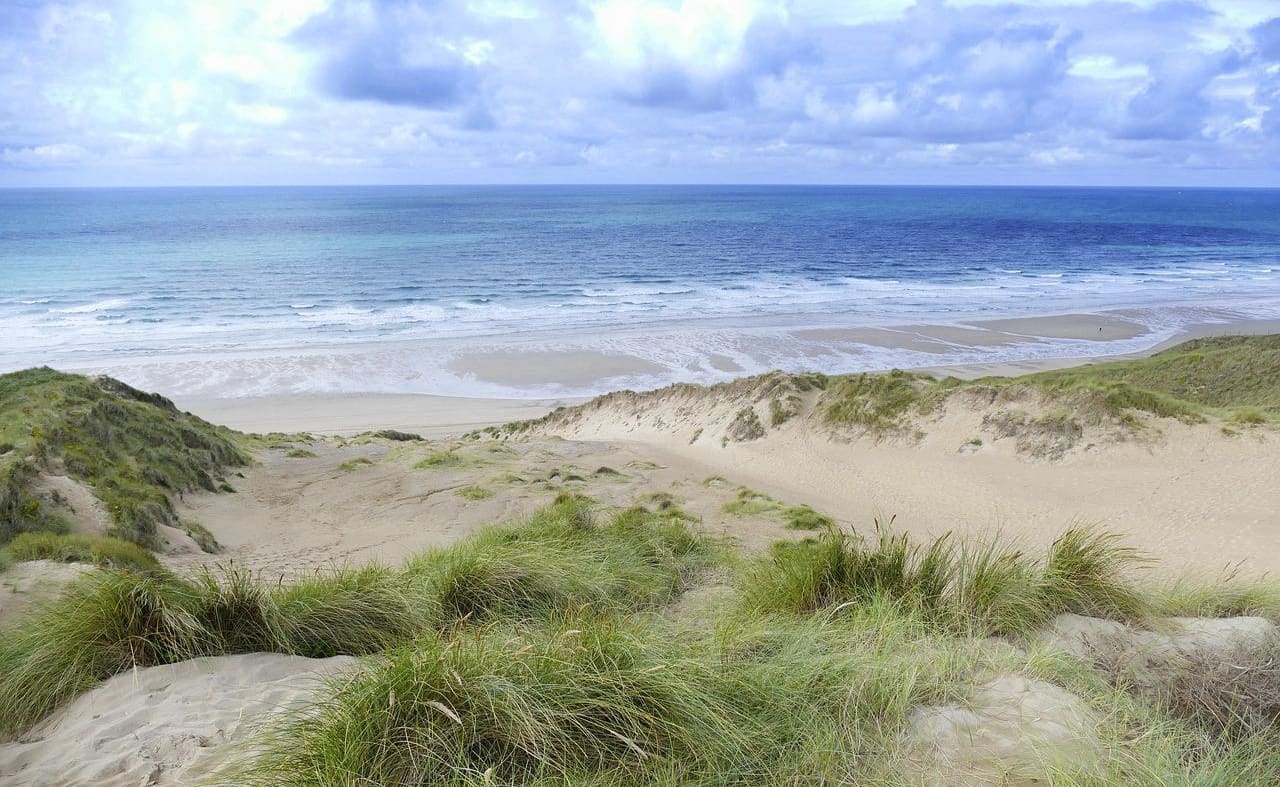 An image of the beach and sea from the South West Coastal Path. image