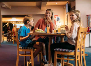 Family enjoying a bite to eat at our Newquay Bay Holiday Park. image