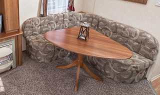 The living and dining area of our budget-friendly value static caravan. The perfect way to stay. image