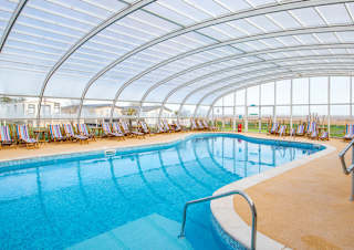 One of our spacious indoor swimming pools with a glass archway roof. Located at our holiday park in Mersea Island, Essex.