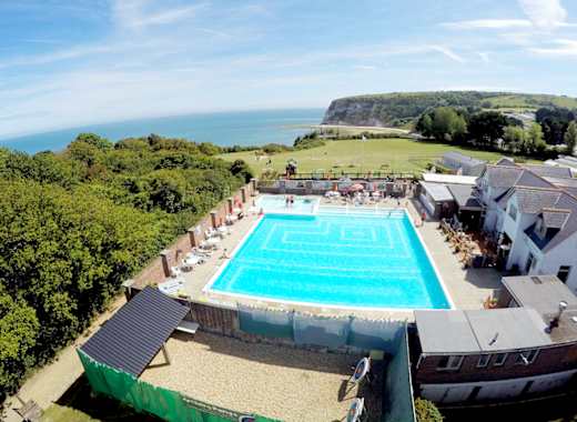 A hot summer's day overlooking our outdoor pool at Whitecliff Bay. Come see for yourself when you visit the Isle of Wight on your next caravan holiday.
