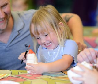 Young girl pottery painting at one of our Away Resorts parks.