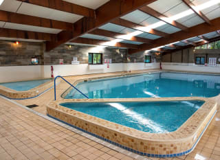 An image of a indoor swimming pool with clear blue water at one of our holiday parks. image
