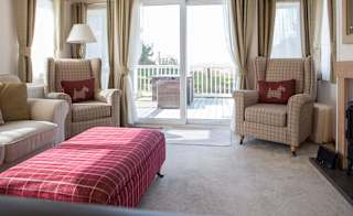 The lounge area of our bright and spacious indulgent static caravan. The perfect way to stay. image