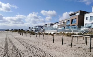 An image of Sandbanks Beach in Dorset. You can see the golden sand and houses overlooking the beach. image