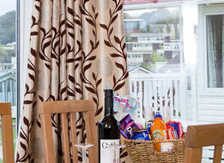 The interior of one of our Superior lodges. There's a dining area with three large windows. image