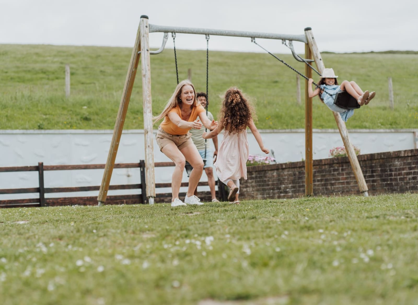Family enjoying our playground area ta Newquay Bay Holiday Park. image