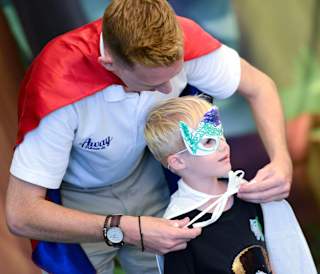 A young boy taking part in our Superhero activity.