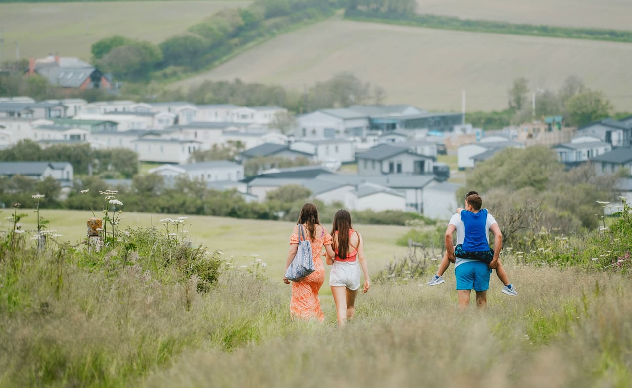 Family walking towards our holiday resort in Cornwall, Bude. image