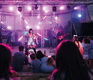 A women performing live on stage.