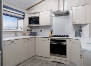 The kitchen area of one of our spacious static caravans in St Ives. Book your holiday now! image