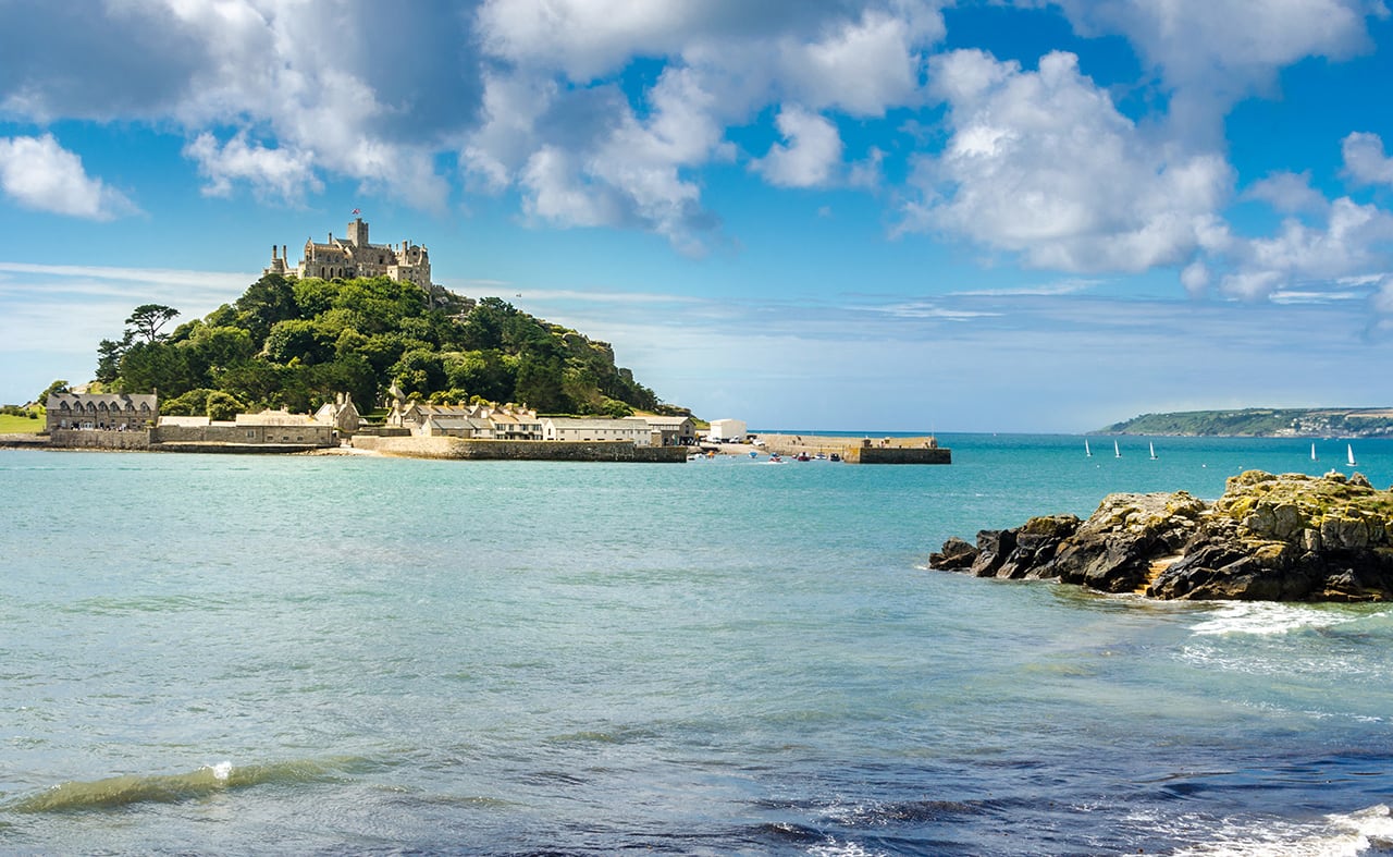 A view of Mounts Bay, Cornwall, on a cloudy but sunny day. There are views of the glorious blue sea and the mount in the distance. image