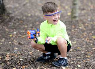 A young boy participating in our Nerf Challenge activity. image