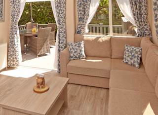 The lounge area of our bright and spacious superior static caravan. The perfect way to stay. image