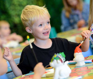 A young boy pottery painting at one of our Away Resorts holiday parks.