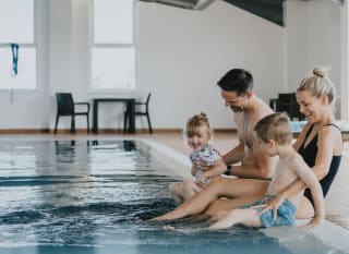 A young family playing in the indoor swimming pool at our holiday resort in Cornwall, Newperran. image