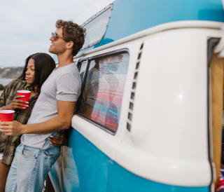A couple enjoying the views once picthed up camping at East Fleet Farm, Weymouth.