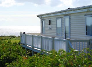 One of our classic holiday homes looking out to sea at our Essex holiday park, Mersea Island. image