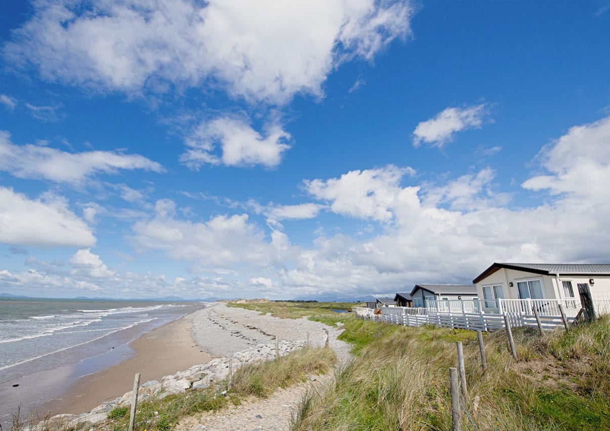 A sunny, cloudy day overlooking the beach at Barmouth Bay, North Wales. Book now to stay in one of our luxury static caravans.