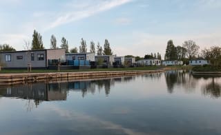 A view of our stunning holiday homes over the lake at Mill Rythe, Hampshire. image