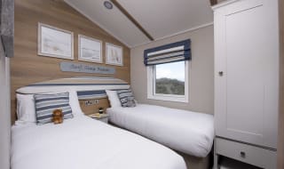 The twin bedroom of one of our spacious static caravans in St Ives. Book your holiday now! image