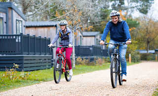 An image of two people cycling through on of our parks together. image