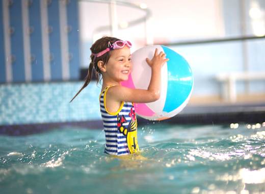 A young girl playing in a indoor pool at our caravan holiday park Golden Sands, North Wales.