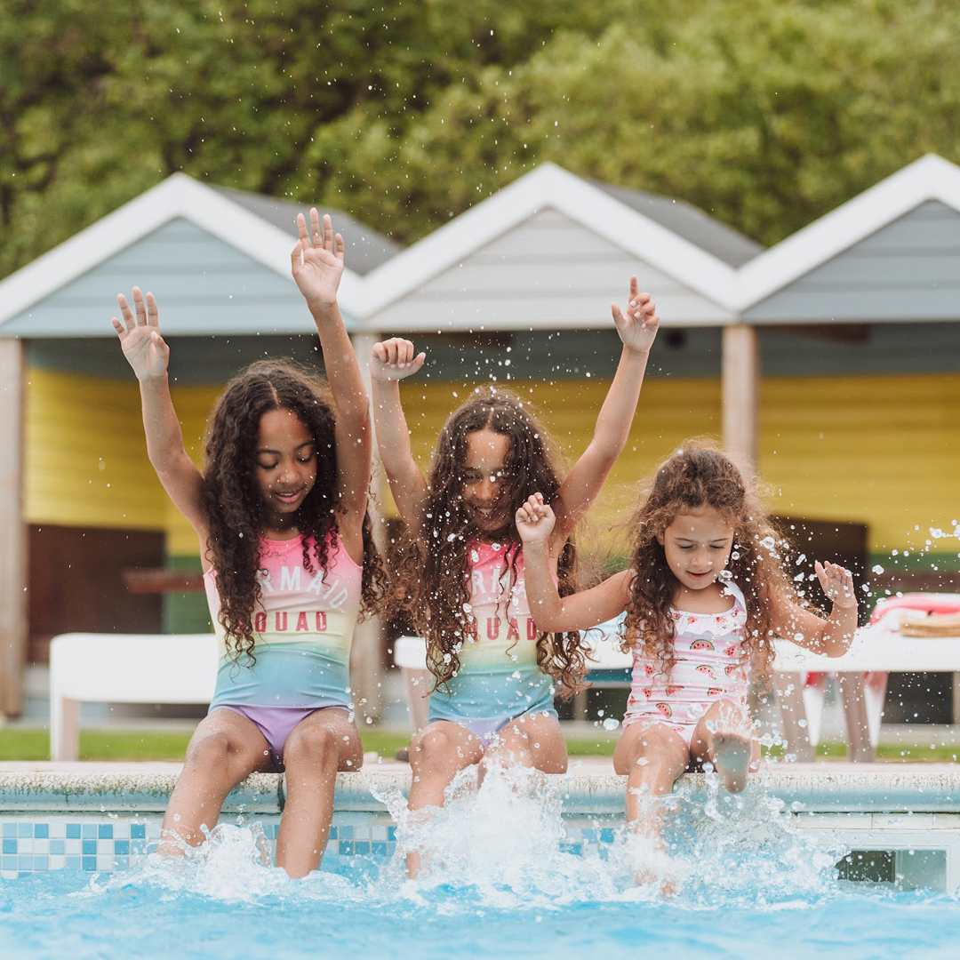 Girls playing in the outdoor pool at Newquay Bay Holiday Park.