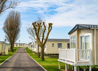 A row of caravans at our park in Essex, Mersea Island on a sunny, cloudy day. image