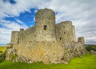 An image of Harlech Castle in North Wales on a sunny, cloudy day. image