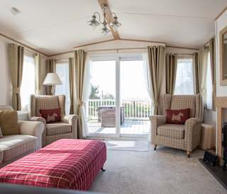 The lounge area of our bright and spacious indulgent static caravan. The perfect way to stay.
