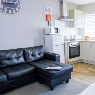The living and kitchen area of our bright and cosy comfort chalet. The perfect way to stay.