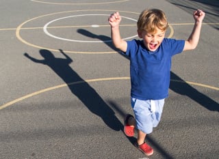 An image of a child celebrating a win on our sports court! image