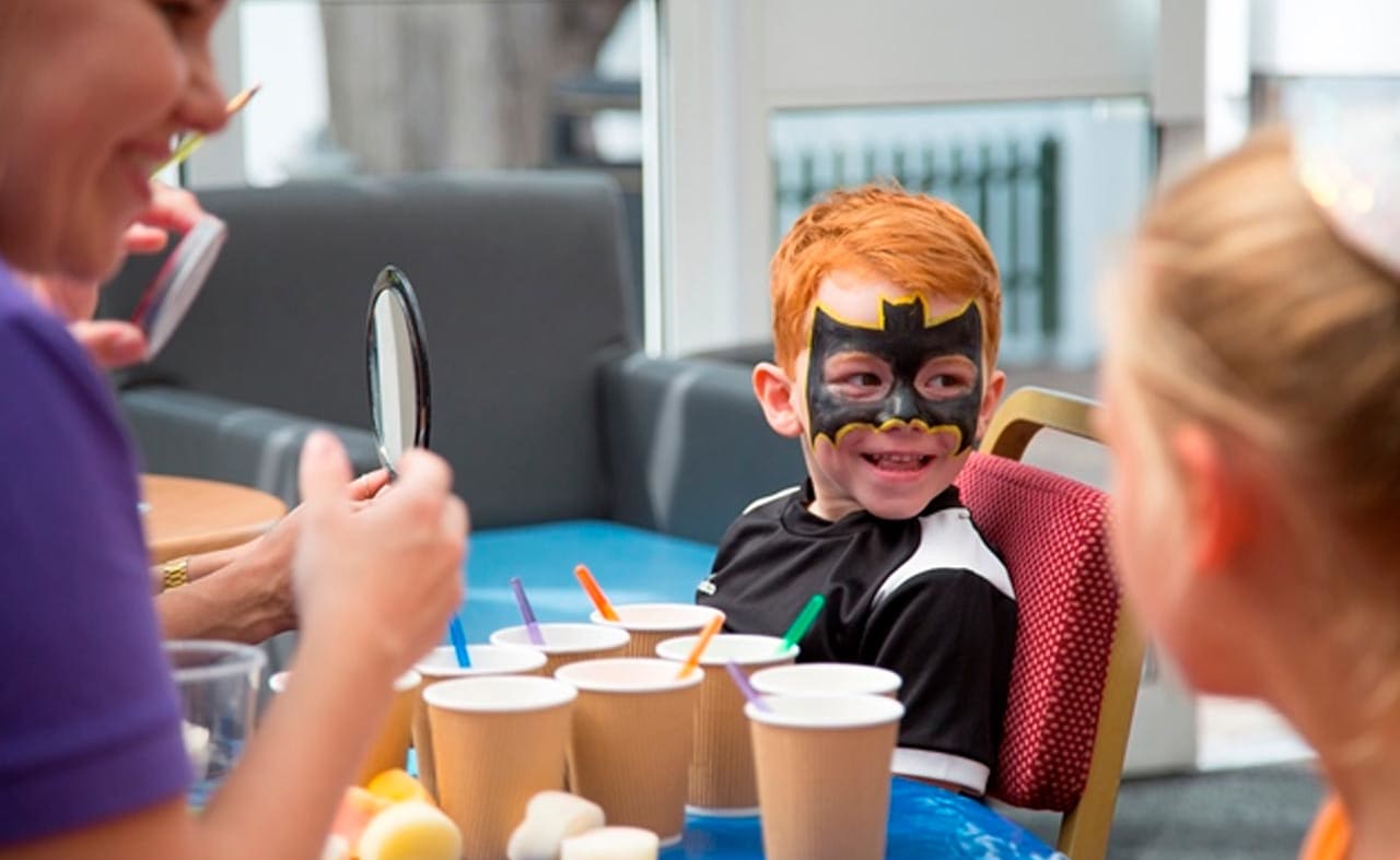 Two young children enjoying one of our awesome on-site activities, the Superhero Academy. image