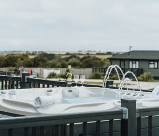 One of our stunning accommodations with a hot tub and a bottle of bubbly, relaxation at it's finest!