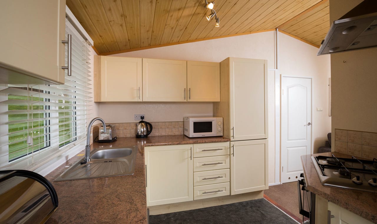 The interior of one of our Superior lodges. There's a spacious kitchen area with multiple appliances. image