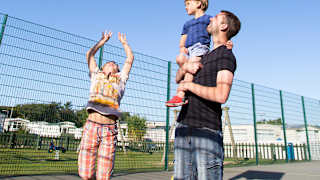 A family enjoying the outdoor sports court at our stunning park in North Wales, Barmouth Bay.