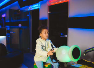 An image of a child playing in the arcade at one of our holiday parks. image
