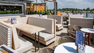 An image of an outdoor seating area on a balconey looking out to the river at one of our holiday parks.